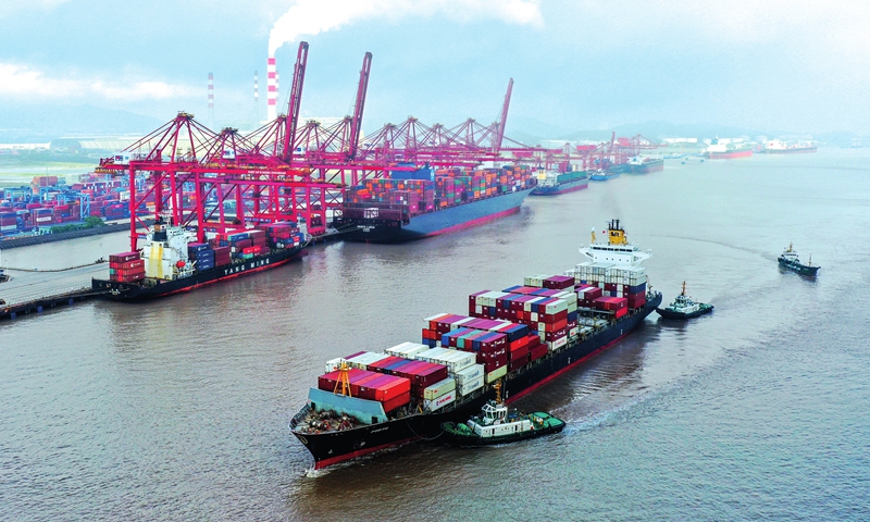 Cargo ships carrying containers pile up at the Ningbo Zhoushan Port in Ningbo, East China's Zhejiang Province on Tuesday. The boom in container throughput for foreign trade comes as the country's yuan-denominated exports jumped 30.1 percent year-on-year in the first five months, customs data showed Monday. Photo: cnsphoto